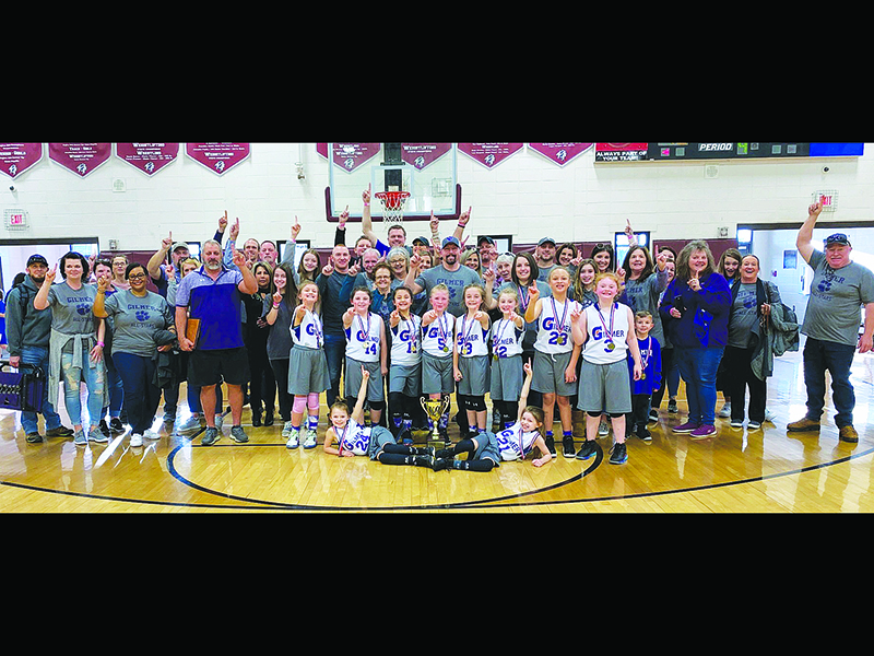 Joining 8-under all-star basketball coaches Ashley Phillips and Brady West and fans are the Class C state champion Gilmer Lady Cats. Front row, from left are Kensie Farmer and  Ally Phillips. Back row, are Roxy McVey, Brenlee Daniel, Halle Mae West, Alayna Martin, Kensey Pritchett, Lola Howard, Rose Everett and Mattie Jones.