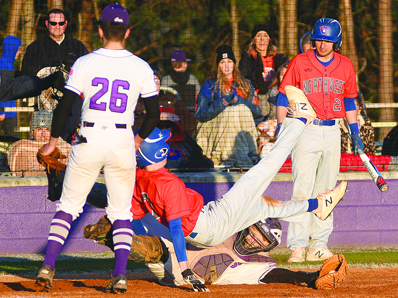 A Northwest Whitfield base runner safely scores following a wild pitch as Gilmer catcher Gabe Wolfson applies the tag.