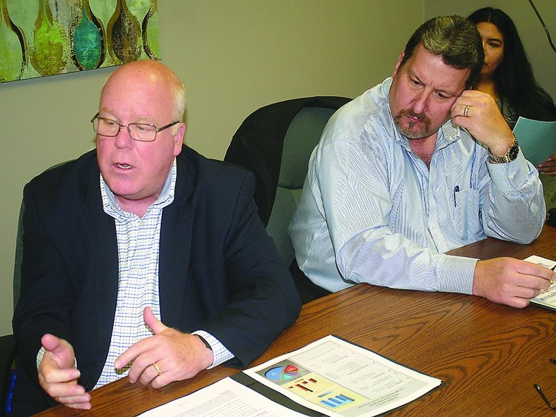 Dr. Zachary Taylor, director of Georgia Department of Public Health District 1-2, left, talks about the Coronavirus and how communities should plan for future cases during last week’s meeting of the Gilmer County Board of Health. Pictured at right is Steve Tonya, health district administrator.
