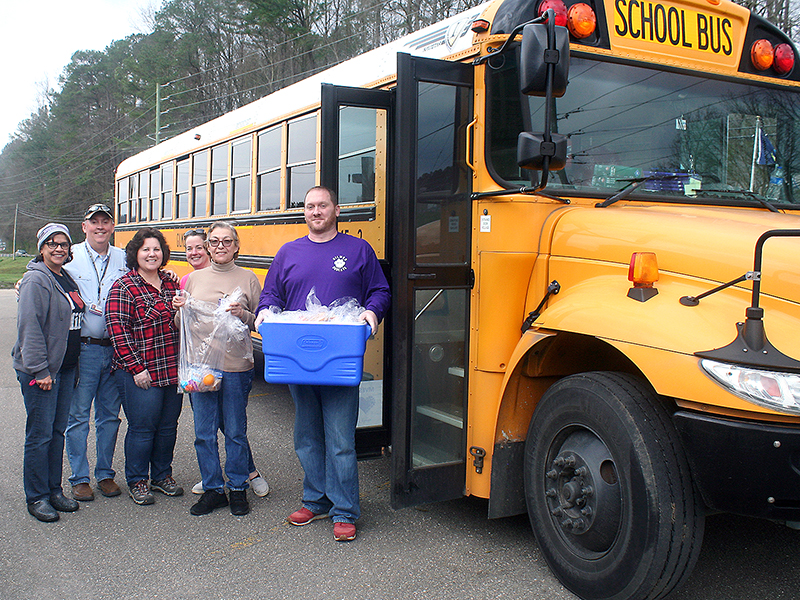 From left, Anne Westlake (Clear Creek Middle School), volunteers Mark and Bernice Marshall, Kristie Cole (Clear Creek Middle School), Dora Martin (Gilmer High School) and bus driver Jacob Dunne were one of the teams of school employees and volunteers who provided lunches and snacks to local students during the first week that Gilmer’s schools were closed in response to the Coronavirus pandemic. The school system served 2,703 meals to the county’s youth through the first six days of the program. 
