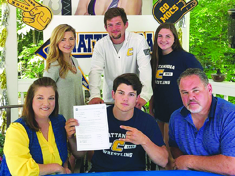 Caleb Waddell, seated center, accepted a scholarship to attend the University of Tennessee — Chattanooga and will wrestle for the Mocs. He is joined by parents Lisa and Mark Waddell. Standing,  are siblings Rachel, Matthew and Anna.