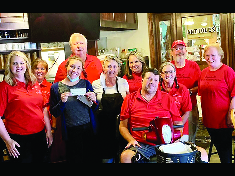 Friends of the Gilmer Animal Shelter (FOGAS) members Rebecca Harrell, Meg Eanes, Tim Vellenoweth, Marla Swanberg, Ernie Taylor, Sylvia Harris, Jack Peaden and Susan Lebert accept a $500 donation from Sammie Jo Hawkins and Terrie Leyden, of Cornerstone Cafe, third and fourth from left.