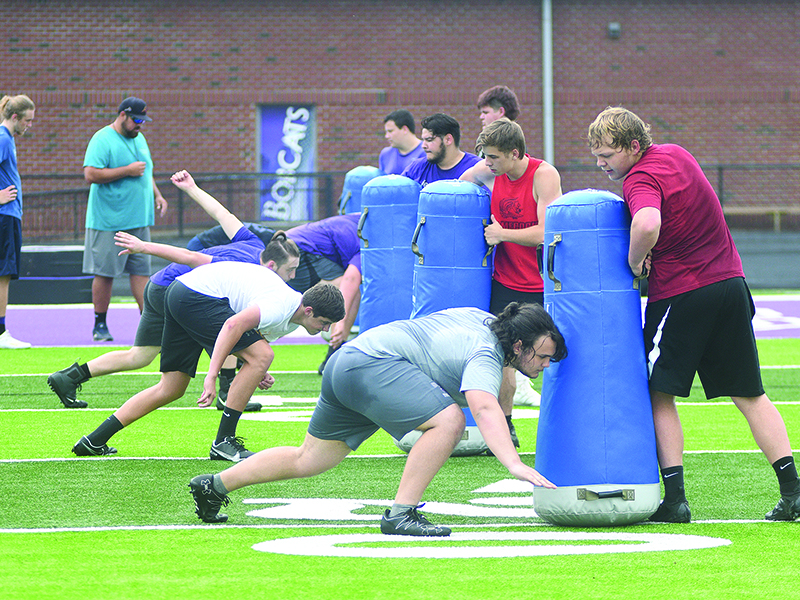 Gilmer High offensive linemen work on their blocking technique during a conditioning session last Wednesday.