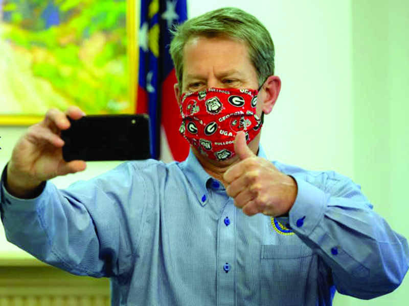 Gov. Brian Kemp posted this photo on social media with the caption, “Wear your mask, Georgia — and Go Dawgs!” Kemp is traveling the state this week to encourage citizens to wear a mask in public to help stop the spread of the coronavirus.