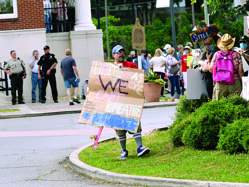 A crowd of people hold up signs during a rally on the square in downtown Ellijay on June 4. Organizers said  the wanted to give people a place to voice their frustrations and concerns over racism.