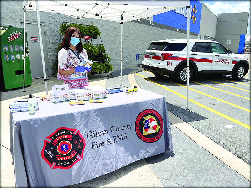 As part of the local COVID-19 community outreach team, Sumner is pictured handing out protective masks and informational cards at the East Ellijay Walmart.