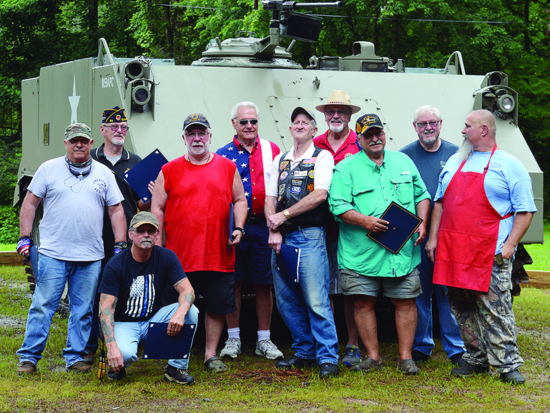 Members of Ellijay’s Ira Cochran American Legion Post 82 and the local American Legion Riders chapter gather in front of a M59 Armored Personnel Carrier (APC) now on display at the local legion post. Pictured, from left, are Steven Petrozella, Michael Menzel, Tim Duffy (kneeling), Keith Harrison, Gary Johnson, Fred McGill, Art Dodge, Phil Simmons, Danny Hall and Brian Shedd. 