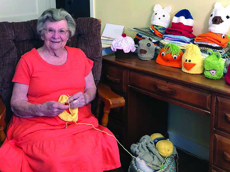 Margorie Adelsperger works on one of 90 hats she’s been knitting for children at St. Jude Hospital.