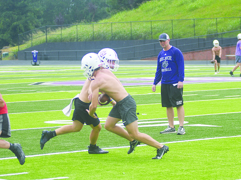 Gilmer High football players continued to work on fundamentals at Monday’s practice. Coach Jeff Thurman makes sure quarterback Spenser Smith and wingback Kobe Stonecipher are using proper technique and following the right track in the backfield as they run through plays.