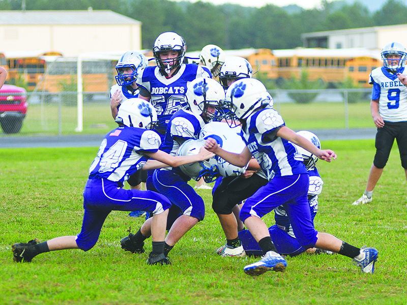 The Clear Creek seventh-grade Bobcats rally to make a gang tackle versus Fannin County last Thursday.
