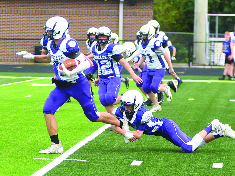 Kyle Cowert tries to bring down running back Talyn Curtis.