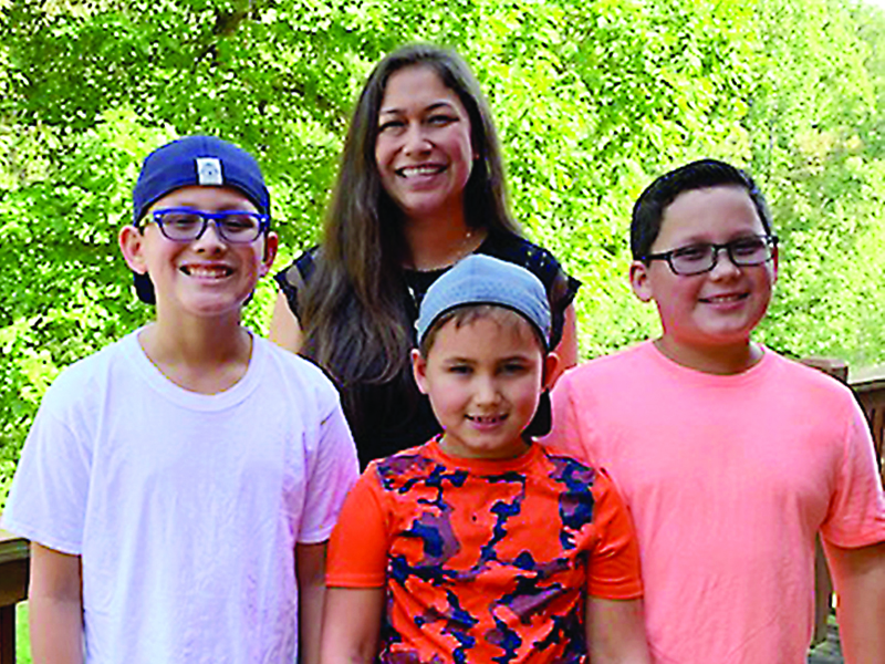 Tiffany Watson, new executive director for Gilmer Family Connection, is pictured in back with her three sons, from left, Luke, Sam and Jake Watson.