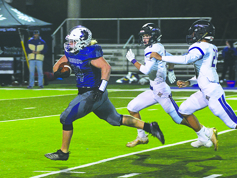 GHS senior fullback Ashton White runs between and then away from two Lumpkin defenders for a 69-yard touchdown last Friday.