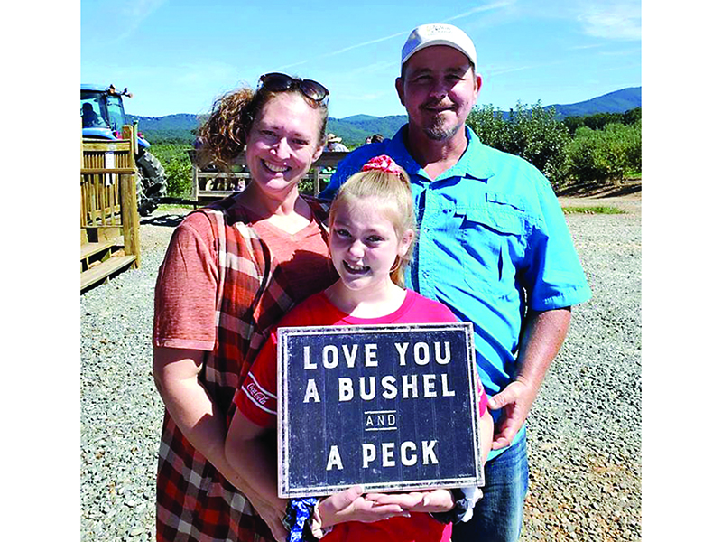 The Burt family, of Dawsonville ­— Amy, Robert and daughter, McKenzie — enjoy a day out at R&A Orchards.