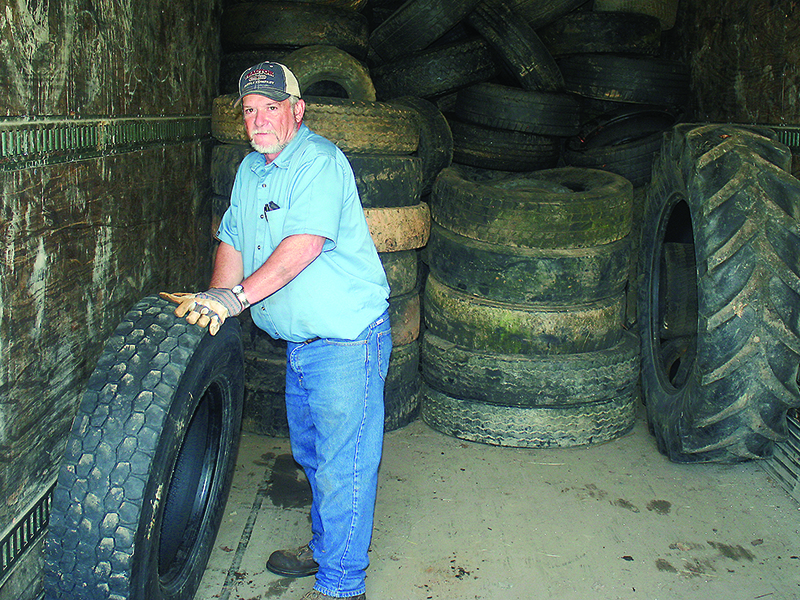 Gilmer County Solid Waste Manager Randy Chadwick is pictured amongst some of the tires that were dropped off at the Tower Road landfill Tuesday, the first day of this year’s Tire Amnesty program.