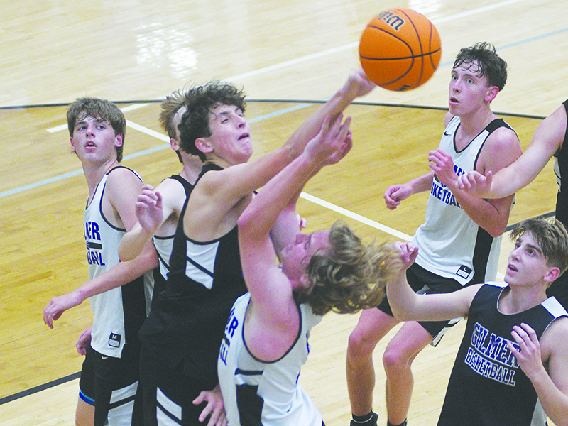 White’s Cooper Bozzo draws a foul against Black’s Britt Taylor during last Tuesday’s basketball scrimmage.