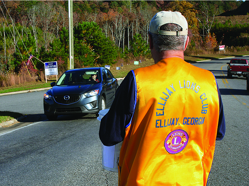 Larry Kenney is shown participating in a past Bucket Brigade collection drive for the Ellijay Lions Club. Donations from the annual Bucket Brigade are used to fund the Ellijay Lions’ White Christmas outreach program. 