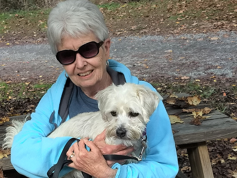 Lynn Robey, a volunteer with Homeward Bound Pet Rescue, enjoys time outdoors with Oscar, a former resident of the Homeward Bound kennel who she adopted.