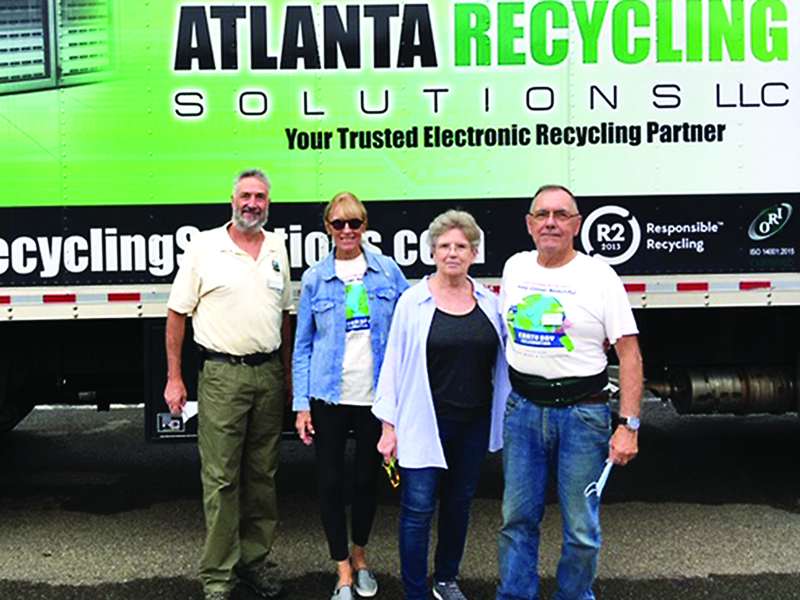 Keep Gilmer Beautiful advisory board members Jay Zipperman, Karen Vitelli, MyKey Cook and Jim Harris are pictured in front of a truck that was filled during the group’s first e-waste recycling event.