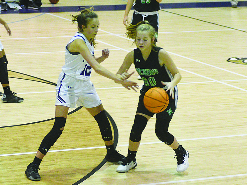 Eighth grader Madison Bradshaw (above in white) defends for Clear Creek.