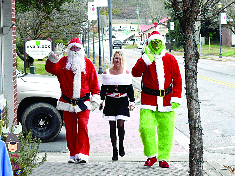 Mr. & Mrs. Clause (Jeff and Susan Ellington) and the Grinch (Rozier Wingate) take a festive stroll through downtown Ellijay Thursday, Dec. 3.