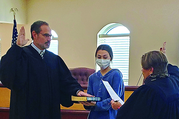 Judge Weaver swears in Probate Judge Scott Chastain for a new term to last from Jan. 1, 2021-Dec. 31, 2024. Also pictured, holding the Bible is Chastain’s daughter, Sara.