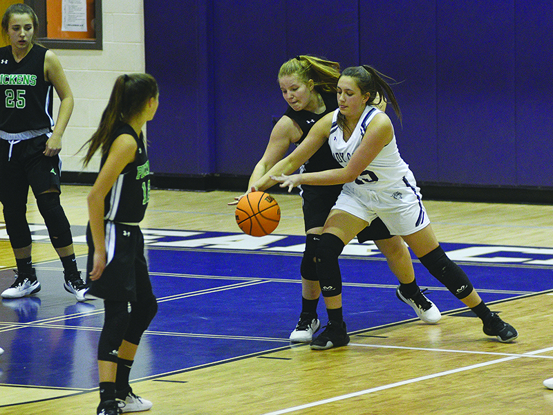 CCMS eighth grader Grace Bramlett (in white) battles for a rebound.