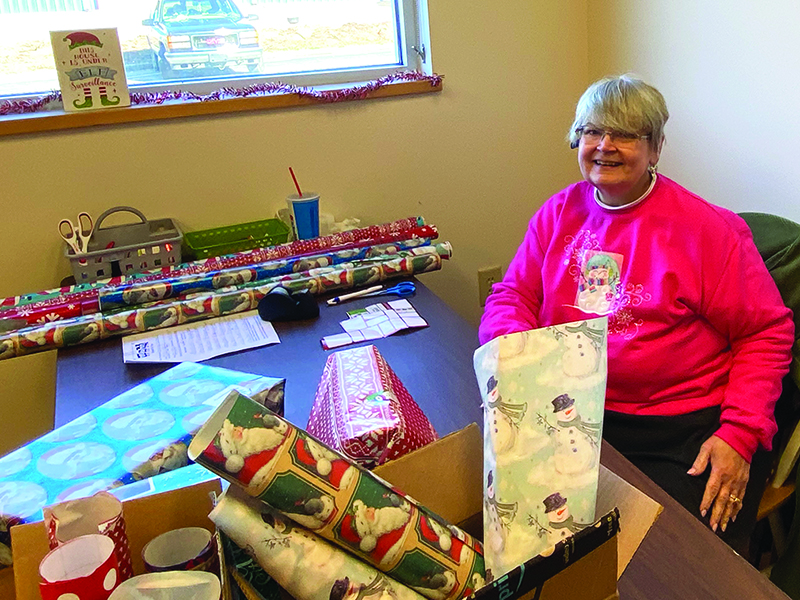 Melinda Cowan, above, and Janice Ross, below, were among those who volunteered to wrap gifts for this year’s Gilmer Toys for Tots campaign, which distributed toys to local families up till Christmas Eve.