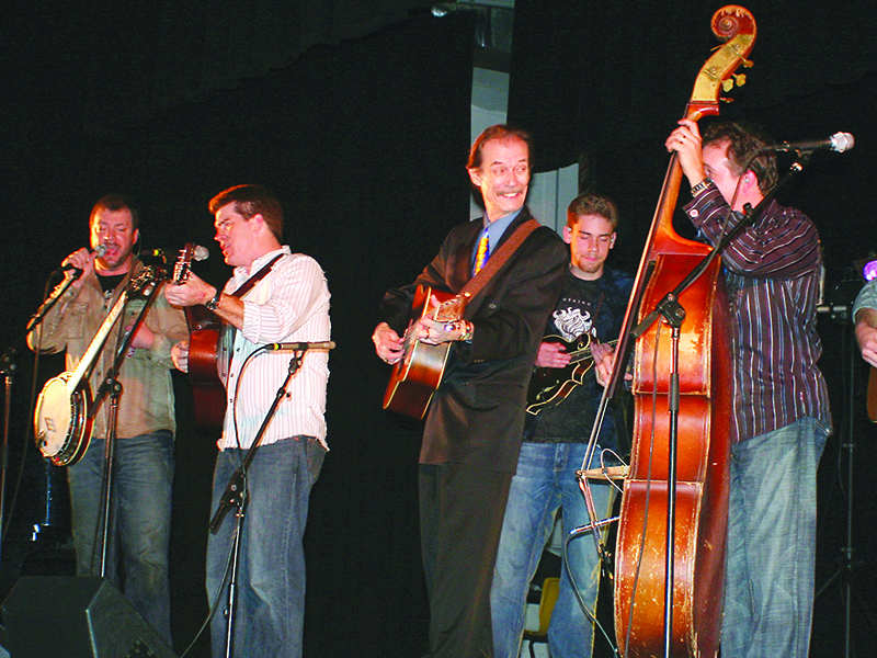 A string of 2008 and 2009 concerts paired guitarist Tony Rice (in suit) with the group Mountain Heart, featuring Barry Abernathy on banjo, at venues including the Grand Ole Opry, above, and the Ellijay Elementary School Auditorium, below. 