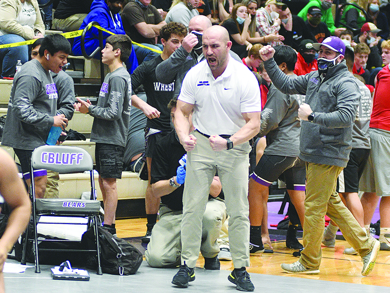 From left, Gilmer High head coach Josh Ghobadpoor and assistant Brent Berry react to a one of the Bobcats’ victories during the Class 3A state duals tournament. 