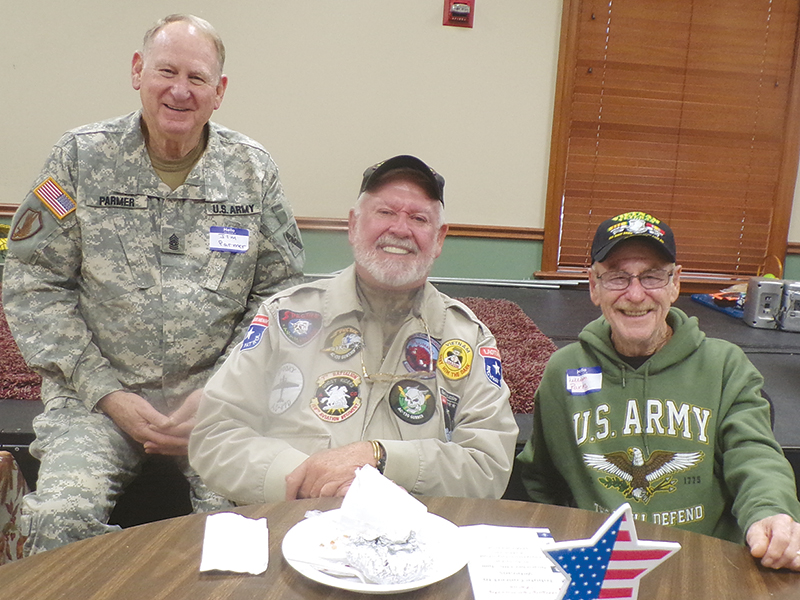 Veterans Jim Parmer, Ben Arp and William Parks are shown enjoying their breakfast.