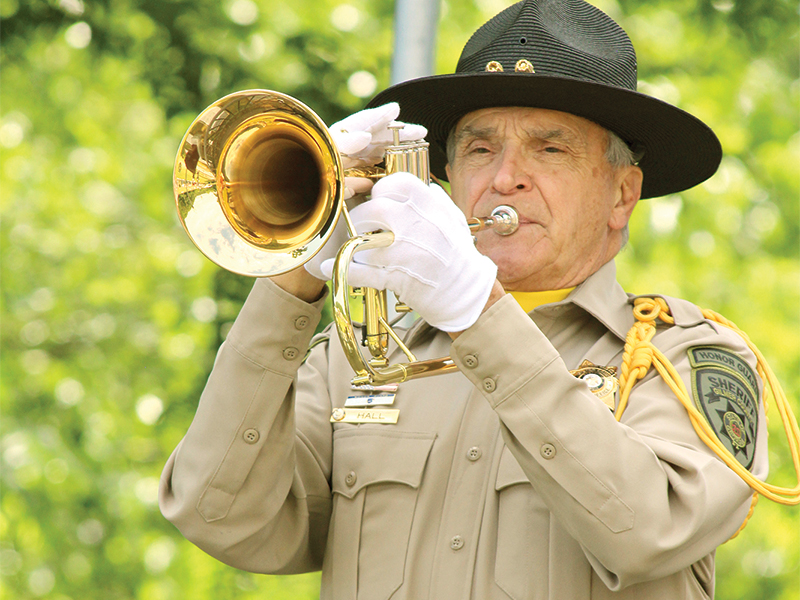 William Hall, an honorary deputy with the Gilmer County Sheriff’s Office, plays “Taps.”