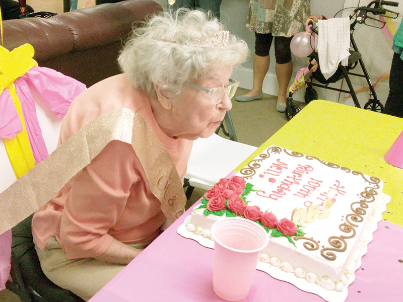 Nell Copeland blows out a ‘100’ candle on her birthday cake during a recent celebration at Brooks Hill Apartments. 