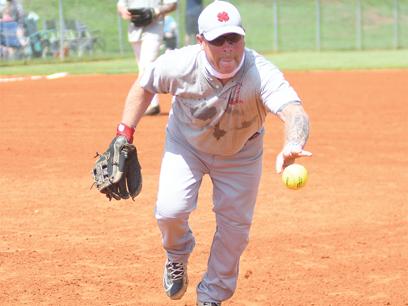 Gilmer Fire Battalion Chief Mike Dempsey  quickly fields a ground ball for an out.