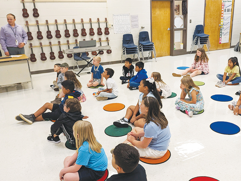 Chandler Bentley’s second grade music students watch a marching band performance.