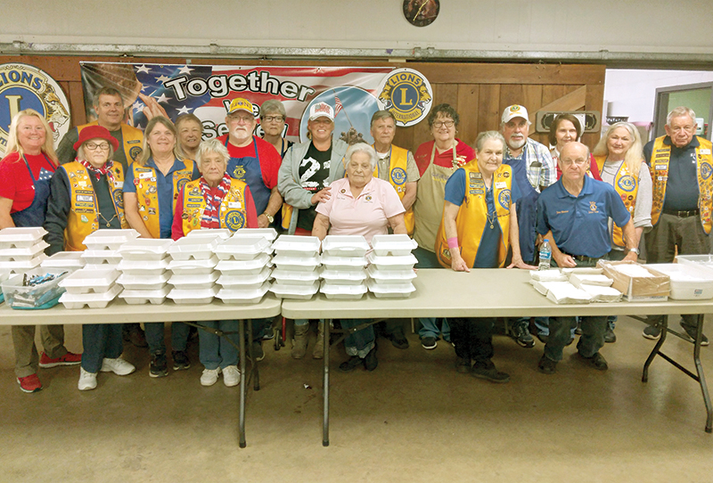 Members of the Ellijay Lions Club served boxed lunches and plenty of desserts to local veterans and their guests Friday afternoon. Pictured are Lions Club members, front: Peg Densmore, Emma Lou Stover, Barbara Barrett, Jane Weaver, Rose Daves, Kathy Watkins and John Weekly. Back: Ted Vickroy, Elaine Adams, Charlie Dixon, Barbara Schrieb, Alicia Dougherty, Chuck Fletcher, Ruthann Harding, Rich Biehl, Merle Howell Naylor, Marie Turner and Ralph Cox.