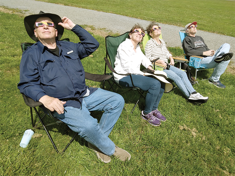 From left, George Riley, Kathy Riley, Debbie Rupp and Jeff Rupp had good seats to view the solar eclipse from Harrison Park Monday afternoon.