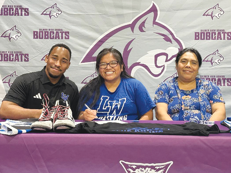 Gilmer High’s Linda Tercero, seated center, will attend Lindsey Wilson College, Ky., and wrestle for the Blue Raiders. Joining Tercero from left are, Lindsey Wilson womens head coach Devane Dodgens and mom Maria Perez.