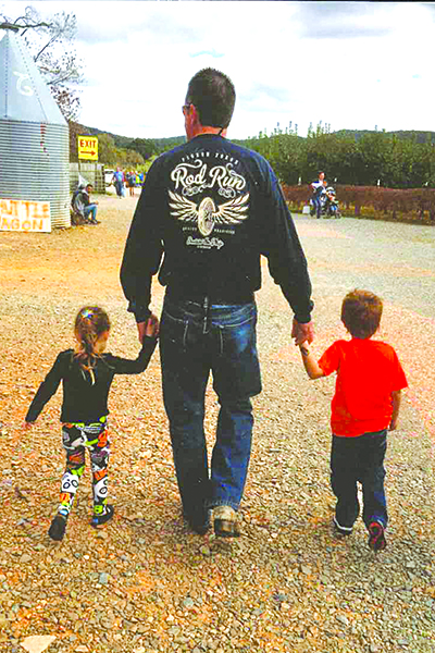 Dale walks with grandkids, Lily Silva and Dean Hunter.