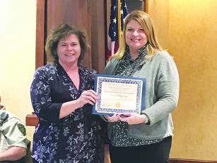 Gilmer County School’s chief financial officer Trina Penland (left) is presented with the Certificate of Achievement for Excellent Financial Reporting by Georgia Department of Audits manager Mary Dilbeck.