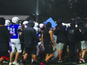 Clear Creek Middle School head coach Willie Dodaro does his best to avoid getting any wetter at the end of the Bobcats’ 20-19 win over Union County that was played in a steady rain.