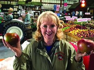 Janice Hale holds up a pair of Rome Beauties at Hillcrest Orchards.