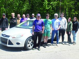 Gilmer High School teacher Ken Martin and students in his second level auto tech class are pictured with a 2014 Ford Focus the school recently received from Ford Motor Company to use for in-class learning. Pictured, from left, back row: Tanner Attebery, Filip Biernacik, James Eves, Martin, Isaac McClure and Nicholas Price; front row: Billy Goswick, Christian Trestrail, Ethan McCollum, Noah Turner, Natalie Key and Kaylie Casady.