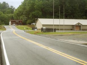 Shrine Club Drive is pictured before, below, and after, above, it was paved and striped last week.