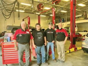 Apple Country Auto Club members Mike Keesee, left, and Mike Bramlett, right, present two new tool chests and an array of tools, also seen below, to Gilmer High School Auto Tech students Robby Sanders, second from left, and Nick Chadwick, third from left. 