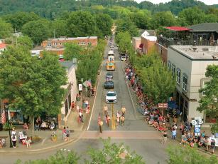 As seen from overhead, Ellijay’s July Fourth parade heads up River Street and toward the town square Monday evening. The parade was followed, of course, by fireworks at dark. See more photos in next week’s edition. (Photo by Robert Ferguson)