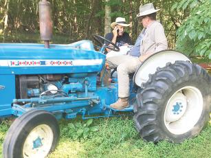 John and Mark Pettit find a shady spot to cool off and hopefully “dial in some rain” on their family cattle farm.