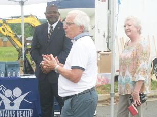 Georgia USDA Rural Development  Director Reggie Taylor, left, and acting Region 1 Director Holly Selph, right, look on as Georgia Mountains Health (GMH) CEO Steven Miracle, center, speaks during a groundbreaking ceremony for a new GMH medical and dental office in East Ellijay. 