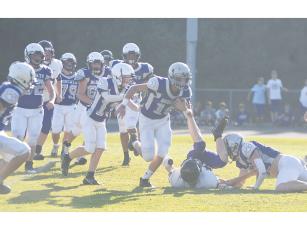 After Clear Creek’s Douglas Callihan (bottom right) forced a fumble versus Lumpkin County last Tuesday, it was recovered by teammate Peyton Chancey and returned for a touchdown .