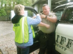 Capt. Brian Crump, of the Gilmer County Sheriff’s Office, gets a flu shot from Leigh Ann Dover, of the Gilmer Health Department, during last year’s drive-thru clinic at the ETC Pavilion. 